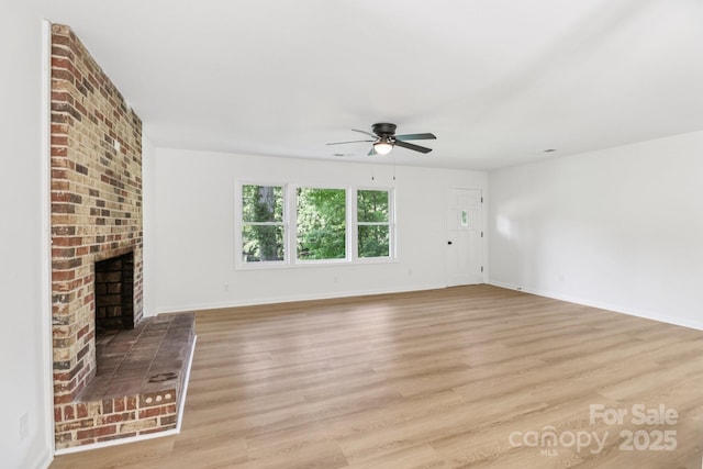 848 Ike Lynch Rd, Dallas, NC 28034 - unfurnished living room featuring ceiling fan, light wood finished floors, and a fireplace