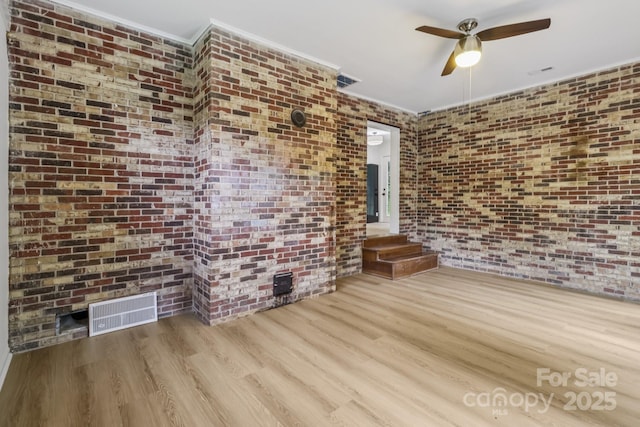 848 Ike Lynch Rd, Dallas, NC 28034 - spare room with wood finished floors, brick wall, ceiling fan, and crown molding