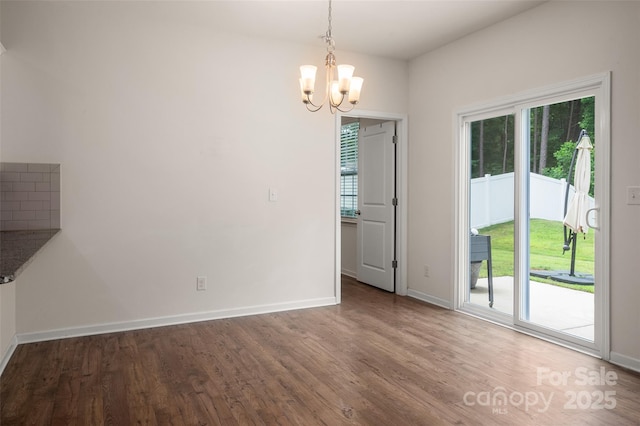 10410 Bradstreet Commons Way, Charlotte, NC 28215 - unfurnished dining area featuring healthy amount of natural light, a chandelier, and wood finished floors