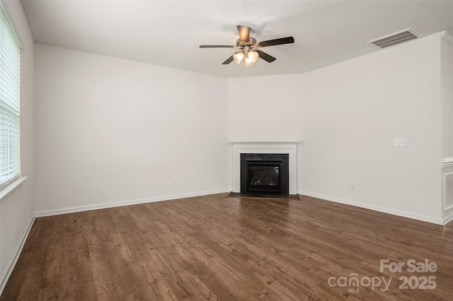 10410 Bradstreet Commons Way, Charlotte, NC 28215 - unfurnished living room with ceiling fan, wood finished floors, and a fireplace with flush hearth