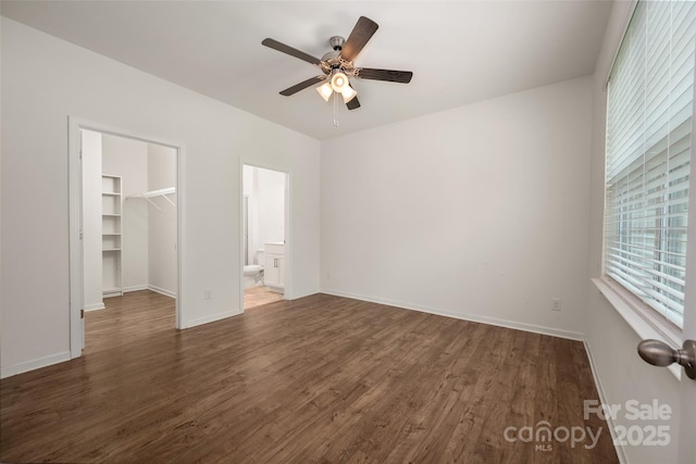 10410 Bradstreet Commons Way, Charlotte, NC 28215 - unfurnished bedroom with a spacious closet, wood finished floors, a closet, ceiling fan, and connected bathroom