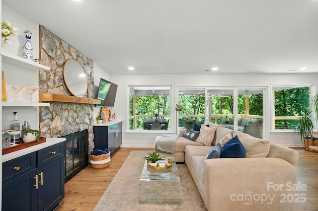 10043 Tepa Pl, Tega Cay, SC 29708 - living room featuring healthy amount of natural light, light wood-type flooring, recessed lighting, and a stone fireplace
