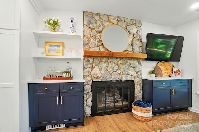 10043 Tepa Pl, Tega Cay, SC 29708 - indoor dry bar featuring light wood-style flooring and a stone fireplace