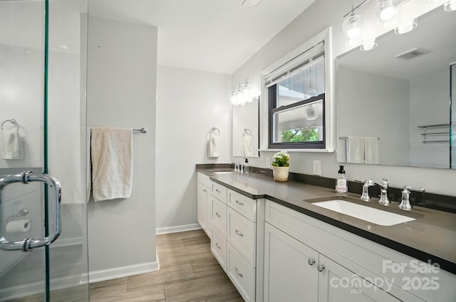 10043 Tepa Pl, Tega Cay, SC 29708 - full bath featuring double vanity, baseboards, and wood finished floors