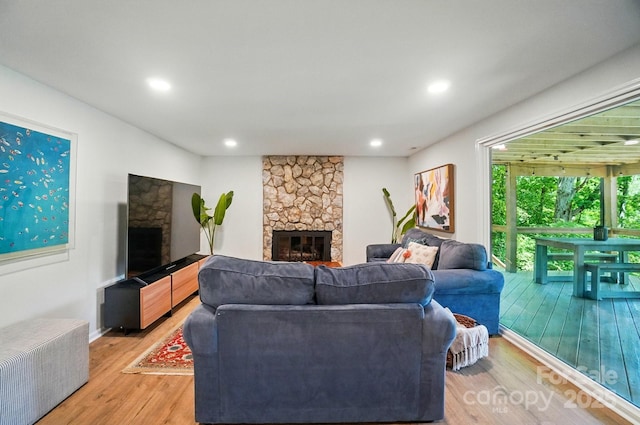 10043 Tepa Pl, Tega Cay, SC 29708 - living area with a stone fireplace, light wood finished floors, and recessed lighting