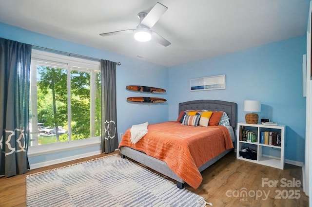 10043 Tepa Pl, Tega Cay, SC 29708 - bedroom with wood finished floors, baseboards, and a ceiling fan