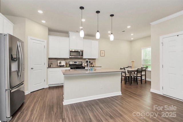 11733 Mesquite Rd, Huntersville, NC 28078 - kitchen featuring stainless steel appliances, dark wood-style floors, decorative backsplash, a center island with sink, and white cabinets