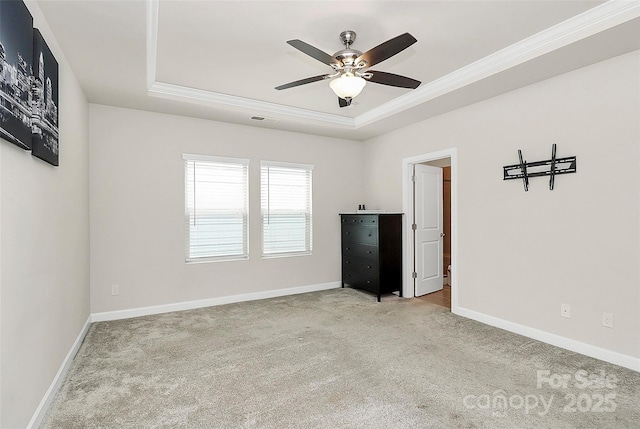 11733 Mesquite Rd, Huntersville, NC 28078 - spare room with a tray ceiling, carpet floors, a ceiling fan, crown molding, and baseboards