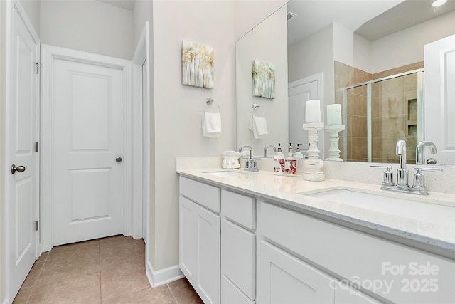 11733 Mesquite Rd, Huntersville, NC 28078 - full bath featuring double vanity, a shower stall, tile patterned flooring, and baseboards