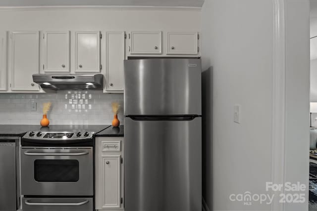 146 Duff St, Gastonia, NC 29715 - kitchen featuring stainless steel appliances, exhaust hood, dark countertops, white cabinets, and decorative backsplash