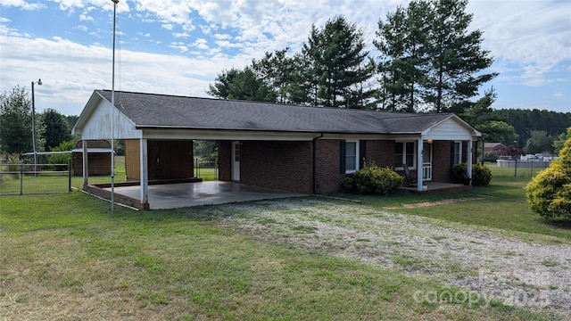 711 Burtonwood Ln, Lincolnton, NC 28092 - exterior space with an attached carport, driveway, covered porch, brick siding, and roof with shingles