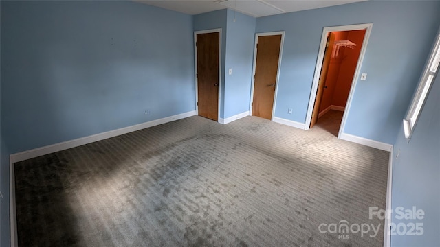 711 Burtonwood Ln, Lincolnton, NC 28092 - unfurnished bedroom featuring attic access, carpet floors, baseboards, a walk in closet, and a closet