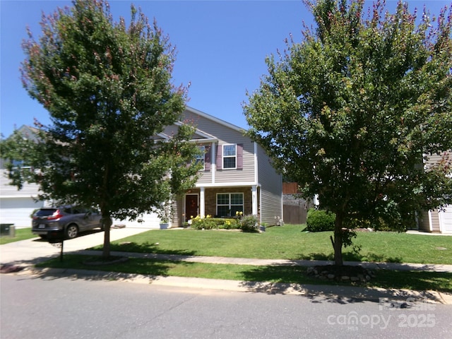 1818 Windy Willow Ln, Dallas, NC 28034 - obstructed view of property featuring a front lawn, a garage, and driveway