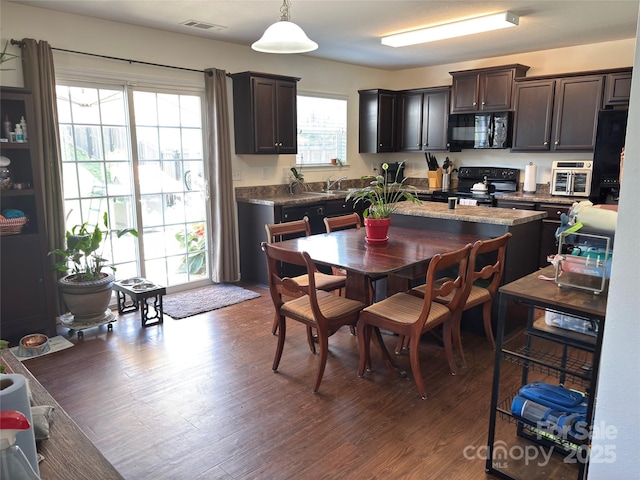 1818 Windy Willow Ln, Dallas, NC 28034 - kitchen with black appliances, dark wood-style flooring, dark brown cabinets, and decorative light fixtures