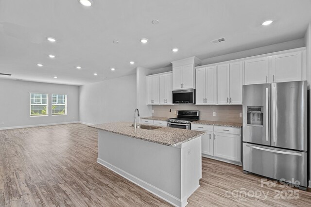 4008 Yucca Aly, Charlotte, NC 28217 - kitchen featuring stainless steel appliances, a sink, recessed lighting, white cabinets, and open floor plan