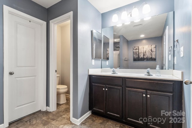 1398 Kent Downs Ave SW Unit 52, Concord, NC 28027 - full bathroom with toilet, double vanity, and baseboards