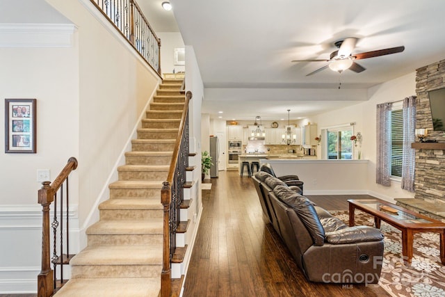 274 Cove Creek Loop, Mooresville, NC 28117 - living area with ceiling fan, dark wood-style floors, stairway, and a chandelier