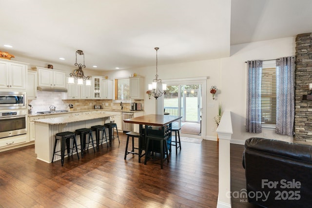 274 Cove Creek Loop, Mooresville, NC 28117 - dining space featuring a chandelier, dark wood finished floors, and recessed lighting