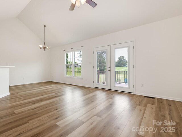 7006 Lone Eagle Dr # 18, Monroe, NC 28110 - spare room featuring a chandelier, wood finished floors, ceiling fan, french doors, and high vaulted ceiling