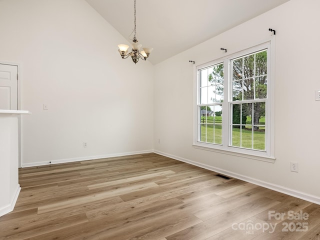 7006 Lone Eagle Dr # 18, Monroe, NC 28110 - unfurnished room featuring a chandelier, plenty of natural light, light wood-style flooring, and high vaulted ceiling
