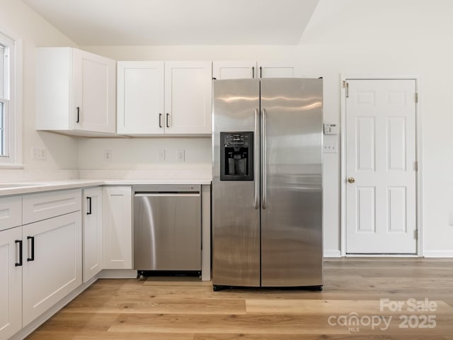 7006 Lone Eagle Dr # 18, Monroe, NC 28110 - kitchen featuring stainless steel appliances, white cabinets, light countertops, and light wood-style flooring
