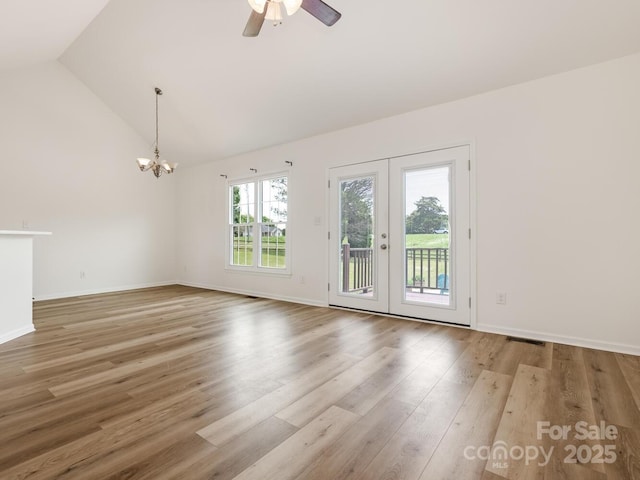 7006 Lone Eagle Dr # 18, Monroe, NC 28110 - unfurnished room featuring a chandelier, wood finished floors, ceiling fan, french doors, and high vaulted ceiling