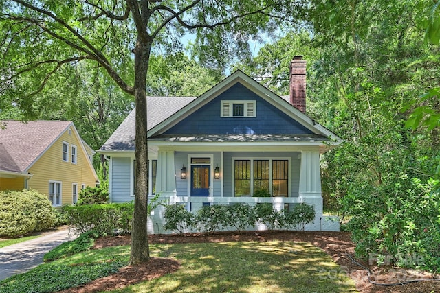 2223 Club Rd, Charlotte, NC 28205 - view of front of property featuring a chimney, covered porch, and roof with shingles