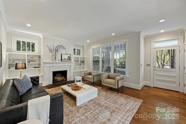 2223 Club Rd, Charlotte, NC 28205 - living area with a fireplace, ornamental molding, wood finished floors, recessed lighting, and built in features