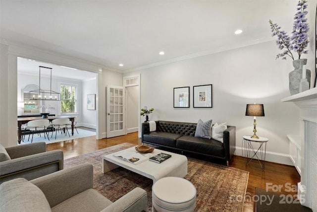 2223 Club Rd, Charlotte, NC 28205 - living room with a chandelier, wood finished floors, recessed lighting, and ornamental molding