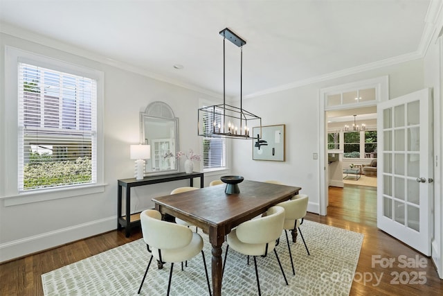 2223 Club Rd, Charlotte, NC 28205 - dining room featuring a chandelier, plenty of natural light, wood finished floors, and crown molding