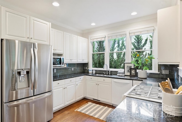 2223 Club Rd, Charlotte, NC 28205 - kitchen with appliances with stainless steel finishes, ornamental molding, white cabinetry, tasteful backsplash, and recessed lighting