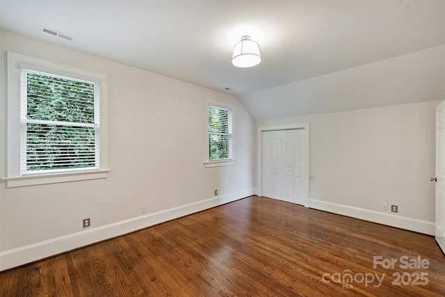 2223 Club Rd, Charlotte, NC 28205 - unfurnished bedroom featuring wood finished floors, vaulted ceiling, and a closet