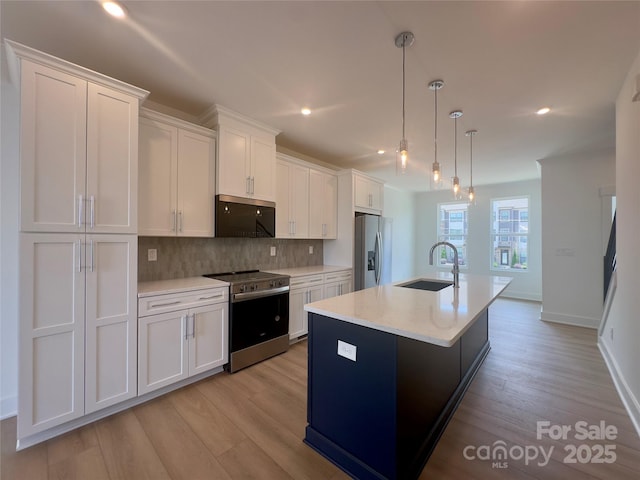 3618 S Tryon St Unit 19, Charlotte, NC 28217 - kitchen featuring stainless steel appliances, a sink, white cabinets, backsplash, and recessed lighting
