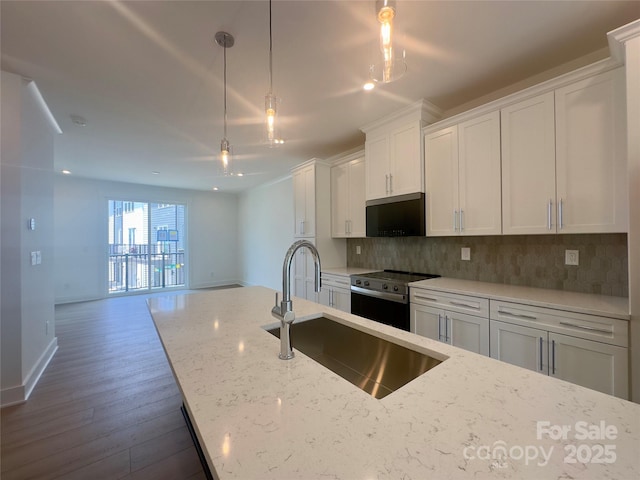 3618 S Tryon St Unit 19, Charlotte, NC 28217 - kitchen with stainless steel range with electric stovetop, a sink, tasteful backsplash, and white cabinets