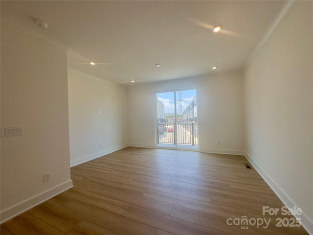 3618 S Tryon St Unit 19, Charlotte, NC 28217 - unfurnished room featuring wood finished floors, baseboards, recessed lighting, and crown molding