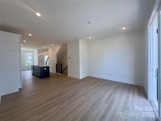3618 S Tryon St Unit 19, Charlotte, NC 28217 - unfurnished living room featuring a sink, wood finished floors, recessed lighting, and baseboards