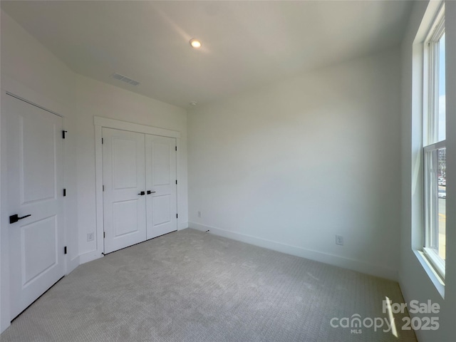 3618 S Tryon St Unit 19, Charlotte, NC 28217 - unfurnished bedroom featuring light carpet, baseboards, a closet, and recessed lighting