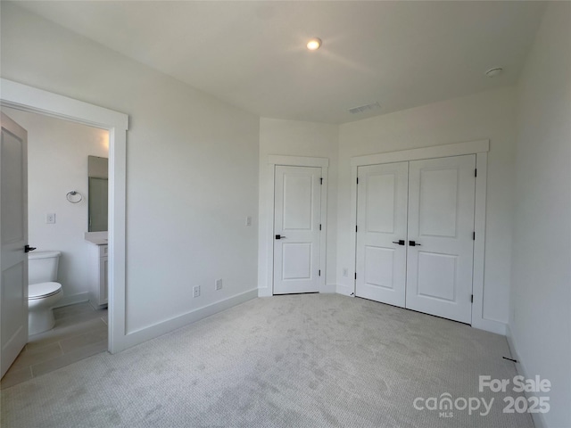 3618 S Tryon St Unit 19, Charlotte, NC 28217 - unfurnished bedroom with carpet floors, ensuite bathroom, a closet, and baseboards