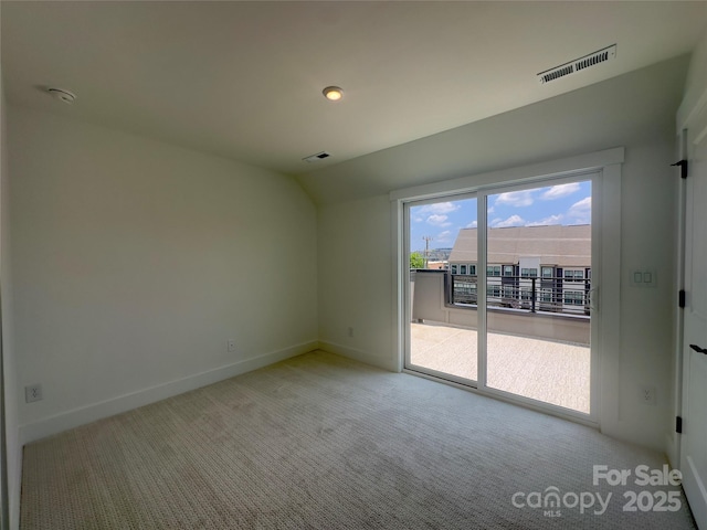3618 S Tryon St Unit 19, Charlotte, NC 28217 - carpeted empty room with baseboards, vaulted ceiling, and a smoke detector