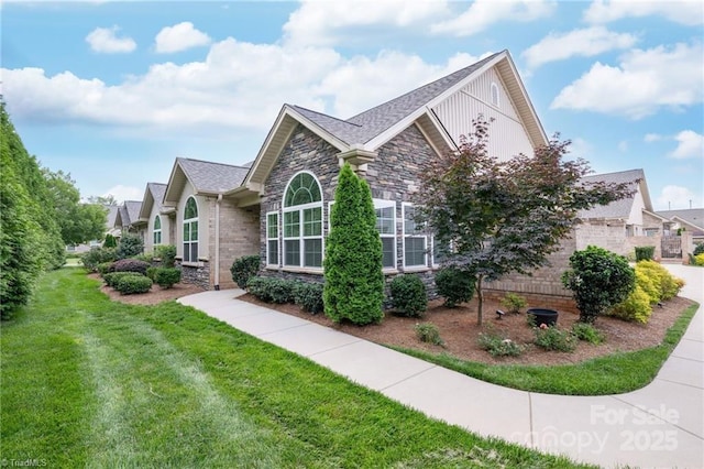 202 Watchtower Ct, Winston Salem, NC 27127 - view of side of home featuring stone siding, a yard, and board and batten siding