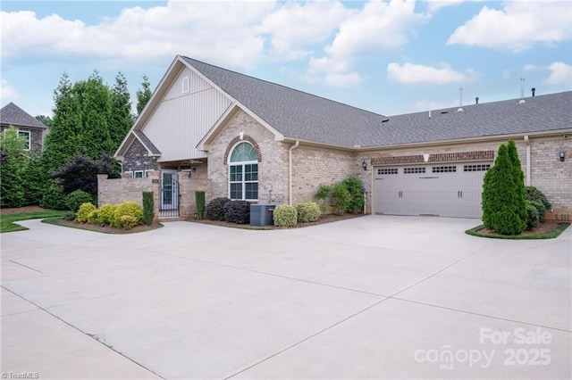 202 Watchtower Ct, Winston Salem, NC 27127 - view of front of property with concrete driveway, brick siding, central AC, and a garage
