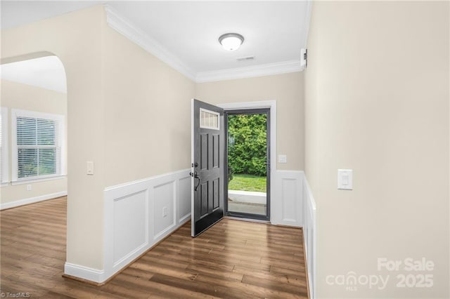 202 Watchtower Ct, Winston Salem, NC 27127 - foyer entrance featuring ornamental molding, wood finished floors, wainscoting, arched walkways, and a decorative wall