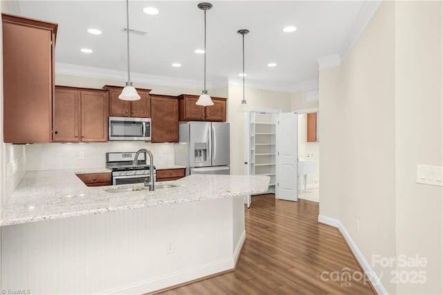 202 Watchtower Ct, Winston Salem, NC 27127 - kitchen featuring stainless steel appliances, a peninsula, ornamental molding, backsplash, and wood finished floors