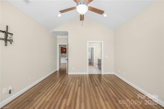 202 Watchtower Ct, Winston Salem, NC 27127 - unfurnished bedroom featuring baseboards, wood finished floors, connected bathroom, high vaulted ceiling, and ceiling fan