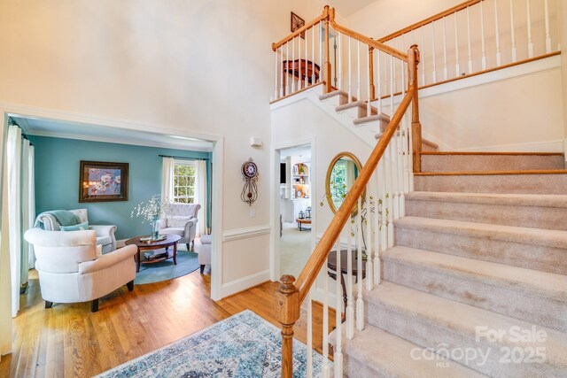 10127 Tallent Ln, Huntersville, NC 28078 - staircase featuring wood finished floors, baseboards, and a towering ceiling