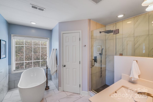 10127 Tallent Ln, Huntersville, NC 28078 - bathroom featuring a stall shower, a soaking tub, and recessed lighting