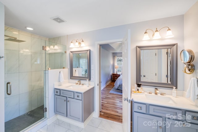 10127 Tallent Ln, Huntersville, NC 28078 - ensuite bathroom featuring two vanities, a stall shower, and baseboards