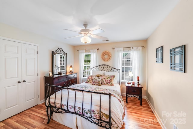 10127 Tallent Ln, Huntersville, NC 28078 - bedroom featuring light wood-type flooring, a closet, baseboards, and a ceiling fan