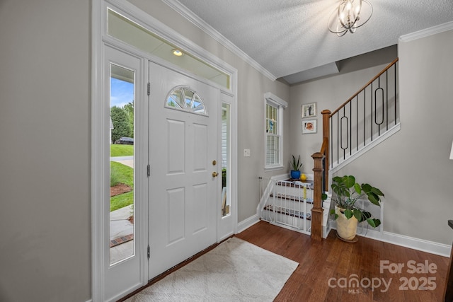 201 Windsor Forest Cir, Fletcher, NC 28732 - entrance foyer with a textured ceiling, stairway, wood finished floors, and ornamental molding