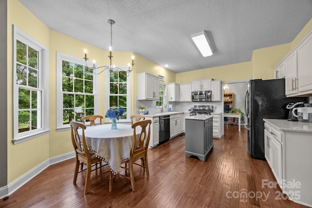 201 Windsor Forest Cir, Fletcher, NC 28732 - kitchen with black appliances, a chandelier, light countertops, a center island, and dark wood-style floors